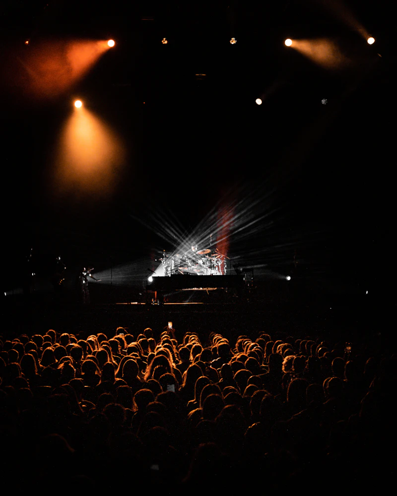 A darkened concert hall under spotlights